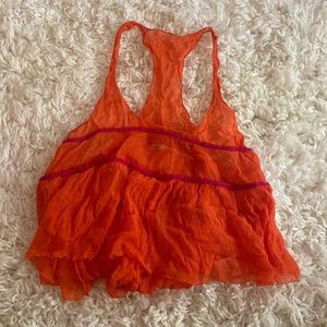 Orange sheer tank with some pink accents. Size small